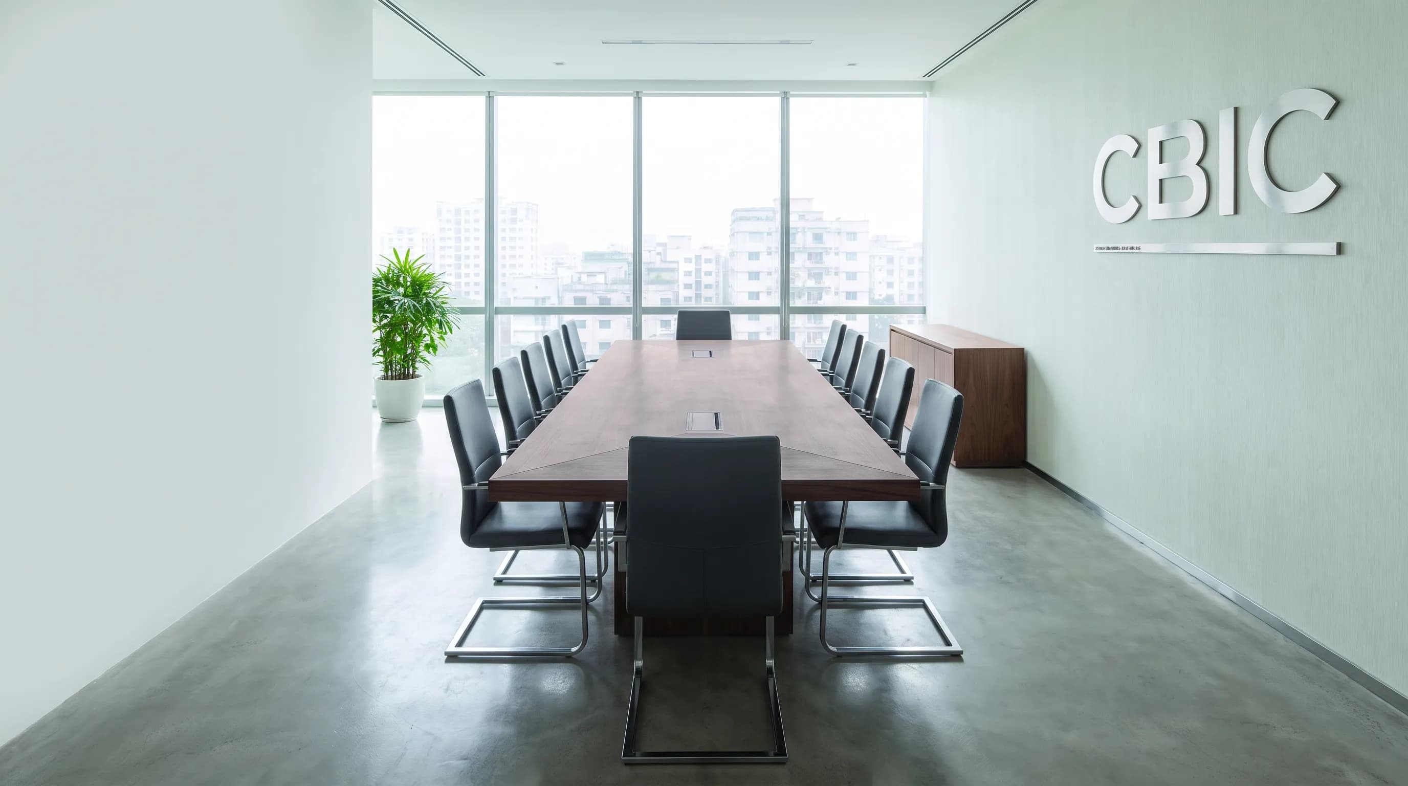 The CBIC boardroom in Dhaka, the branded wall behind an empty conference table